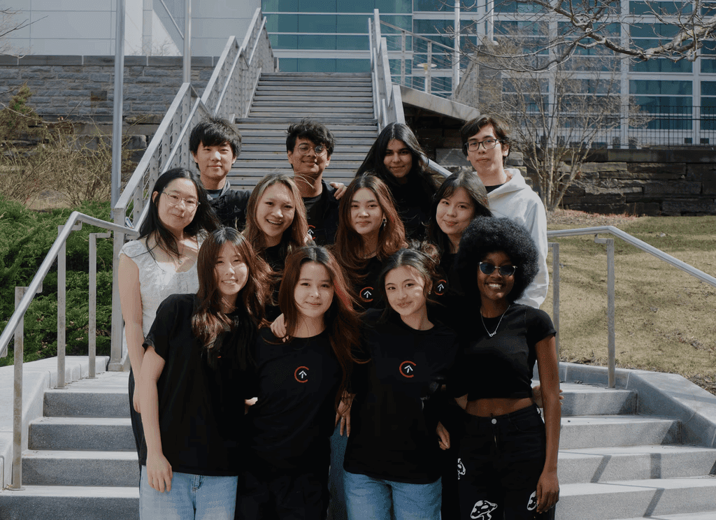 Ashley with the Cornell Digital Tech & Innovation (DTI) team on a staircase